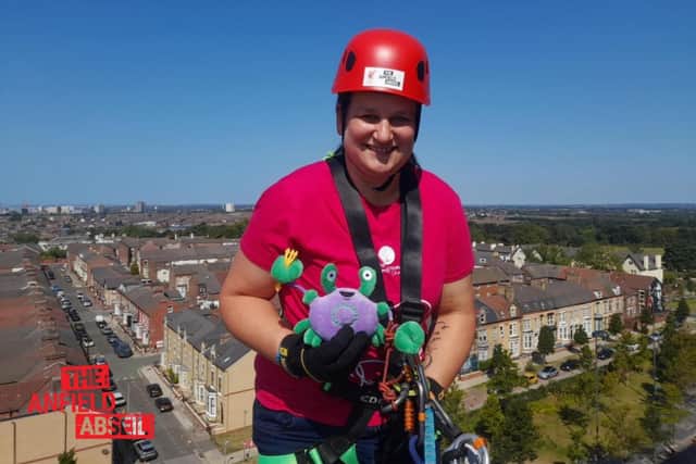 Emma Kane on her abseil down Anfield Stadium, Liverpool FC.