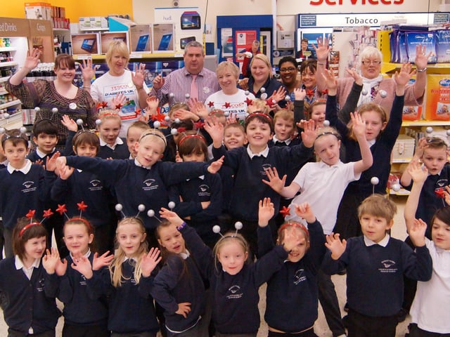 Children from the Falcons class at Market Rasen Primary School with staff at the town’s Tesco store, performing the Cha Cha Slide in aid of school pool roof funds.