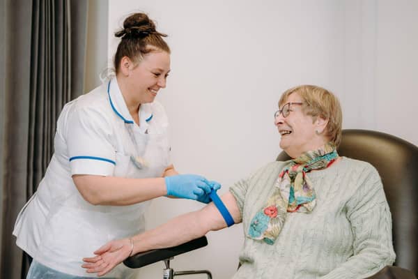 Lucy Walters prepares to taking blood from a patient at Newark Hospital