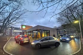 Customers queuing at the new Starbucks drive-thru at 6am for its opening.