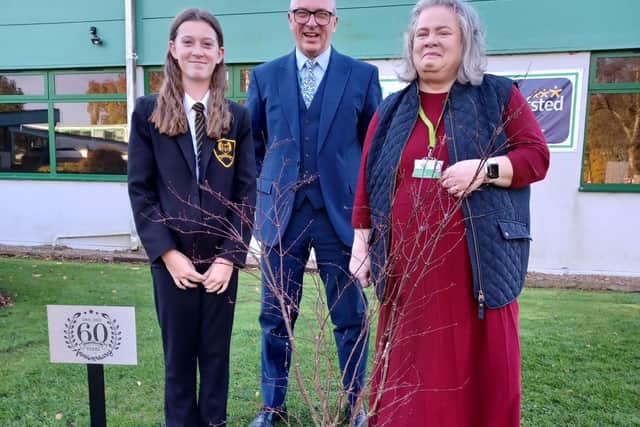 Headteacher Grant Edgar with Chair of Governors Wendy Ireland planting the Acer with Isobel Gosling.