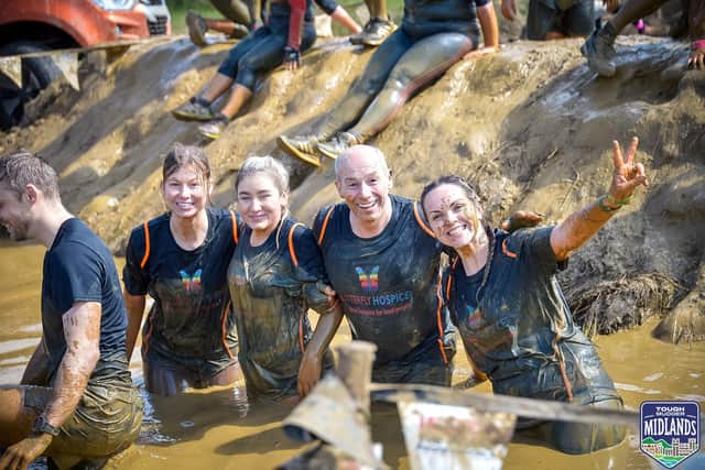 Team Butterfly pose for a group shot during the Tough Mudder 5K challenge in aid of the Butterfly Hospice.