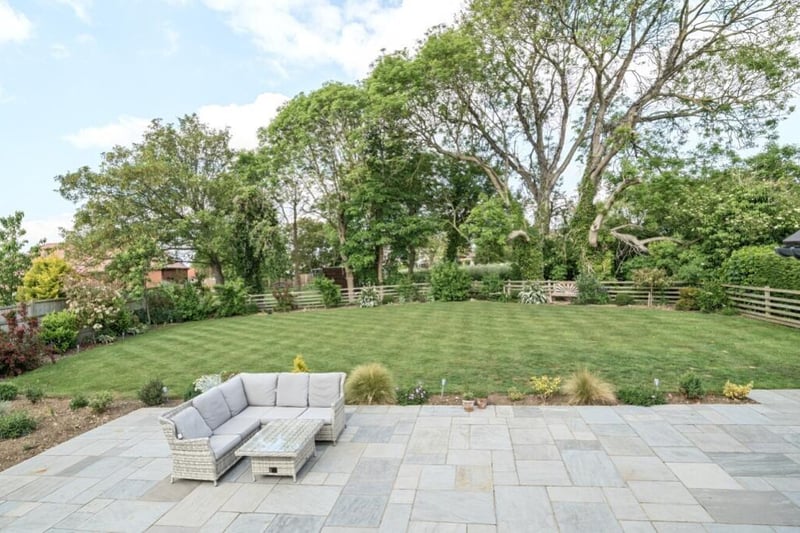 Looking out across the patio and back garden.
