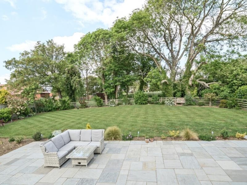 Looking out across the patio and back garden.