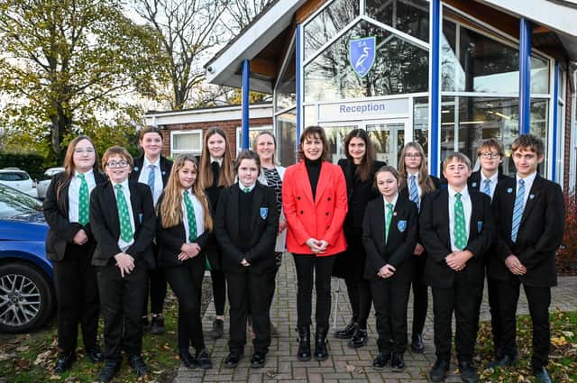 Victoria Atkins (centre) with Somercotes Academy Careers Leader Laura Brown (left) and Principal Frances Green plus some of the students who attended the question-and-answer session. Photo by Jon Corken
