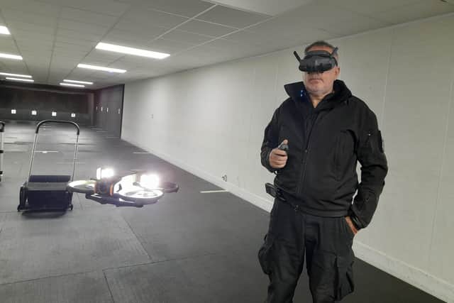 Kev Taylor, Lincolnshire Police's Chief Drone Pilot, uses a headset to pilot an indoor drone at the police HQ. Photo: LDRS