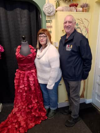 Owner of Kennedy's, Kim Kennedy, with RBL Poppy Appeal organiser Julian Millington with the Poppy Dress. Photo: Lindy Taylor