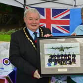 Mayor of Skegness Coun Pete Barry is presented the photo by Terry Allen of the Skegness RAF Association.