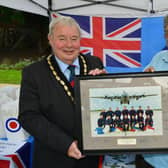 Mayor of Skegness Coun Pete Barry is presented the photo by Terry Allen of the Skegness RAF Association.
