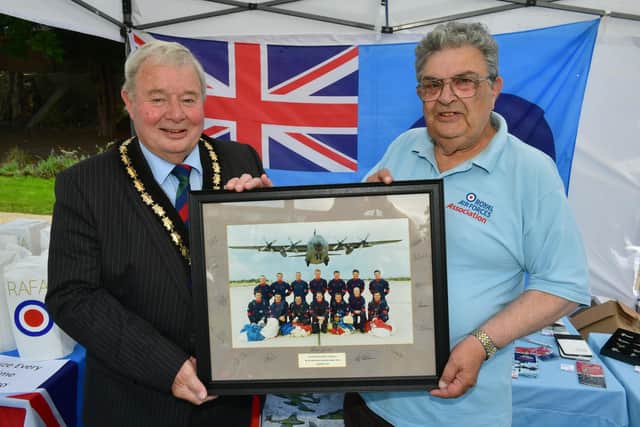 Mayor of Skegness Coun Pete Barry is presented the photo by Terry Allen of the Skegness RAF Association.