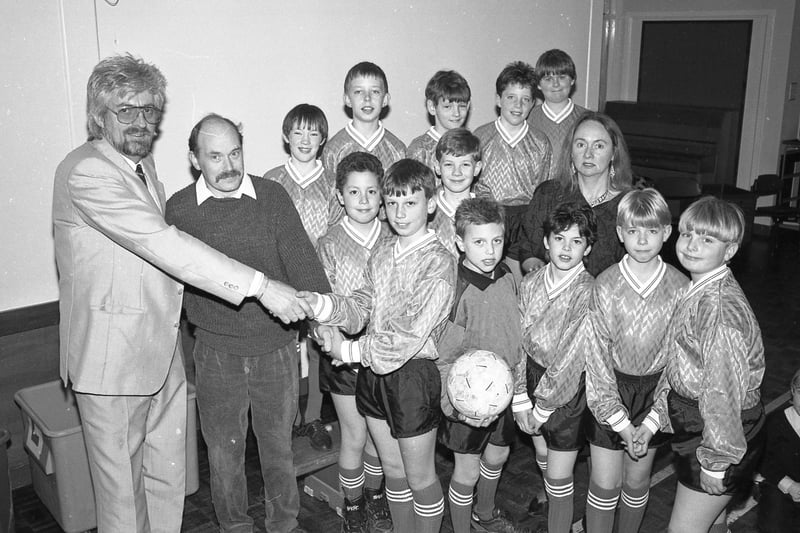Footballers from Sutterton Fourfields Primary School in their new kit. The strip was supplied by local businessman Keith Enderby, of Sutterton Camping, and Tarcon Windows' Dave Bassham, both parents of pupils at the school. Team captain Christoper Patchett is seen here receiving the kit with headteacher Val Morris.