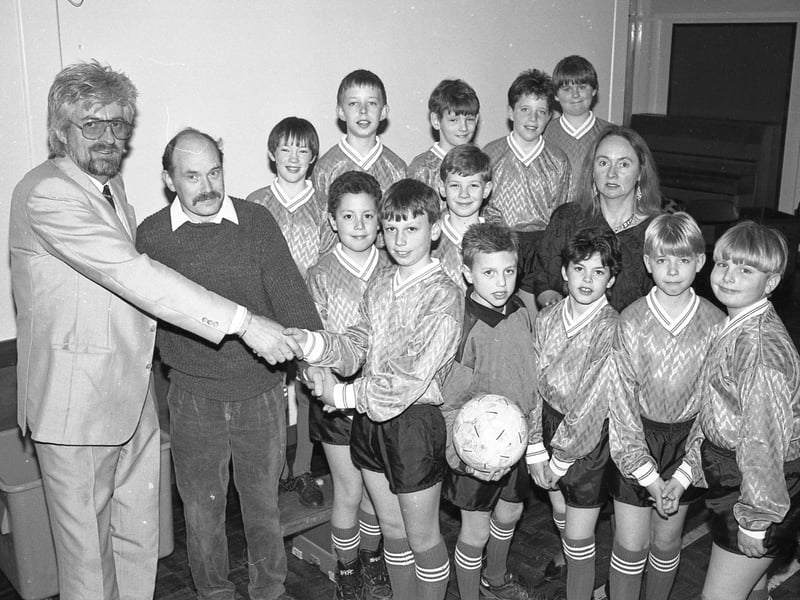 Footballers from Sutterton Fourfields Primary School in their new kit. The strip was supplied by local businessman Keith Enderby, of Sutterton Camping, and Tarcon Windows' Dave Bassham, both parents of pupils at the school. Team captain Christoper Patchett is seen here receiving the kit with headteacher Val Morris.