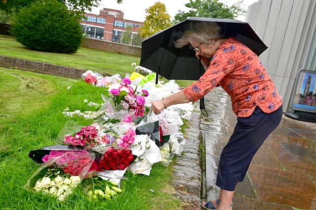 Sandra Lee looking at the floral tributes outside Boston Stump.
