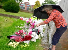 Sandra Lee looking at the floral tributes outside Boston Stump.