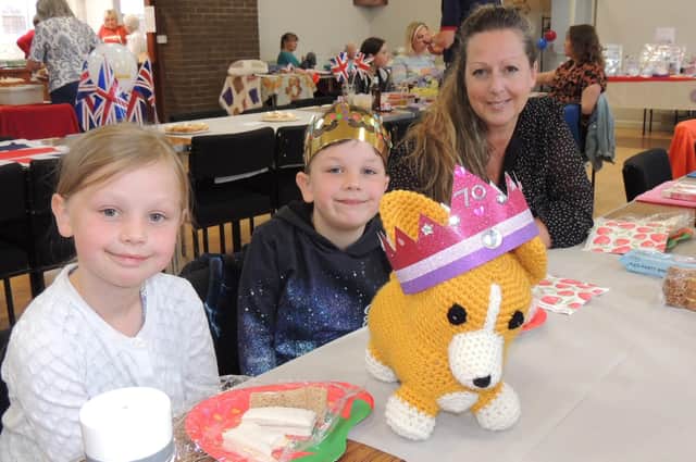 Jessica Scott, eight, Billy Scott, six, and mum Zoe Scott from Great Hale with their knitted corgi, Buster at the village indoor picnic.
