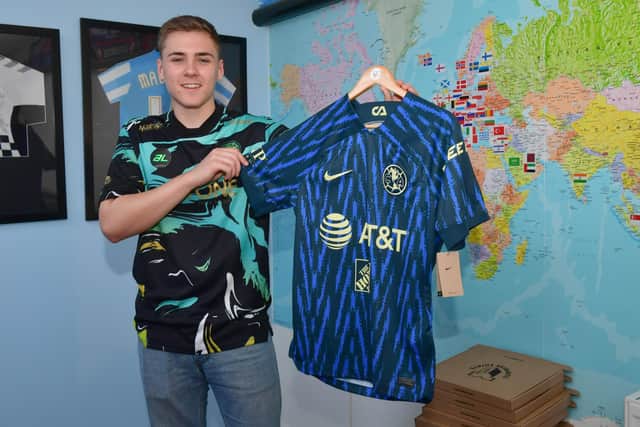 Louis pictured wearing Malaysian team Terengganu's Special Third Shirt from 2021, holding the current Club America away shirt from Mexico.
