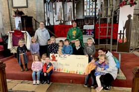 Mon Ami Children's Nursery, in Swineshead, donating funds from its sponsored scarecrow walk to the village's St Mary's Church.
