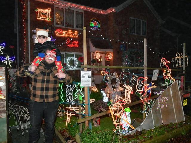 George Wattam with Freddie Wattam, three, enjoying the lights. Photo: David Dawson