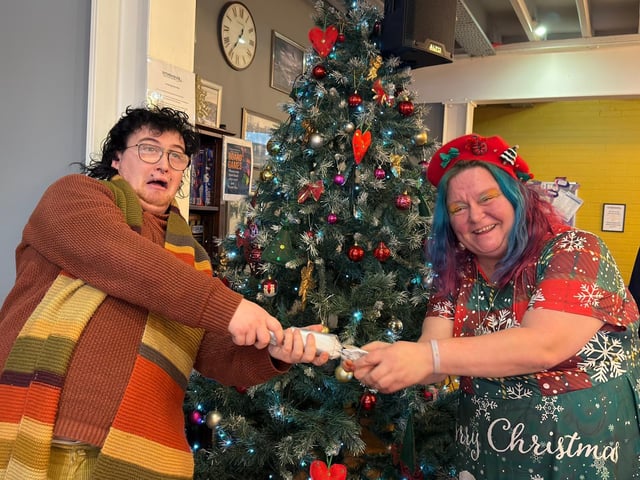 It's a cracker! Jay Hall and Donna Carlton (right) pulling a cracker.