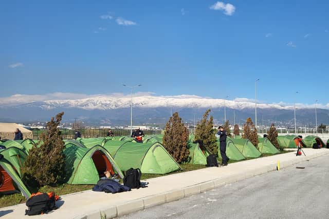 The tent city of the rescue teams in a stadium car park.