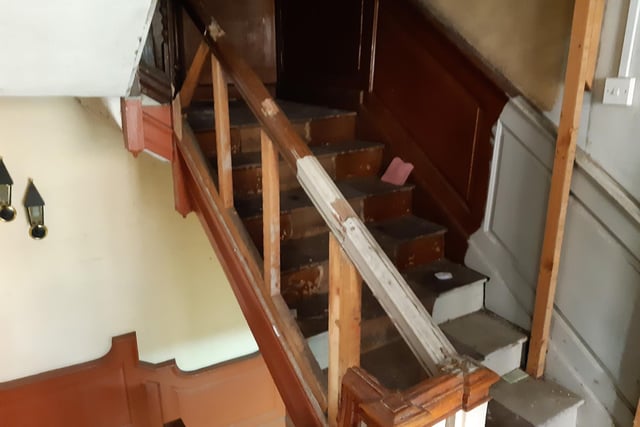 This staircase leads to the attic, but previously it was hidden behind a cupboard. Behind the cupboard, Shane found a staircase full of hat and suit boxes. Upstairs, finds included an old till and financial records dating back decades and evidence of people living there (such as indentations on the floor from bed legs and blisters on the wall from lamps).