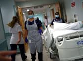 Medical staff transfer a patient along a corridor at the Royal Blackburn Teaching Hospital (Photo: HANNAH MCKAY/POOL/AFP via Getty Images)
