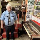 Bill Kibby-Johnson in the old barn which stores his pianos.