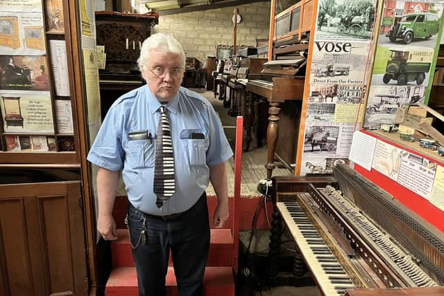 Bill Kibby-Johnson in the old barn which stores his pianos.