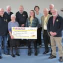 Anne Lewis presents the £250 cheque to Caroline Barnes, a fundraiser for the Lincolnshire and Nottinghamshire Air Ambulance and James Wiggins a volunteer for the same charity, watched by Market Rasen Rotarians. Photo supplied