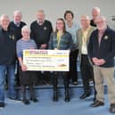 Anne Lewis presents the £250 cheque to Caroline Barnes, a fundraiser for the Lincolnshire and Nottinghamshire Air Ambulance and James Wiggins a volunteer for the same charity, watched by Market Rasen Rotarians. Photo supplied