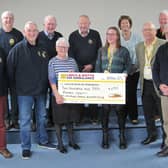 Anne Lewis presents the £250 cheque to Caroline Barnes, a fundraiser for the Lincolnshire and Nottinghamshire Air Ambulance and James Wiggins a volunteer for the same charity, watched by Market Rasen Rotarians. Photo supplied