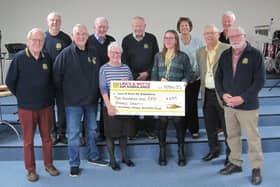 Anne Lewis presents the £250 cheque to Caroline Barnes, a fundraiser for the Lincolnshire and Nottinghamshire Air Ambulance and James Wiggins a volunteer for the same charity, watched by Market Rasen Rotarians. Photo supplied