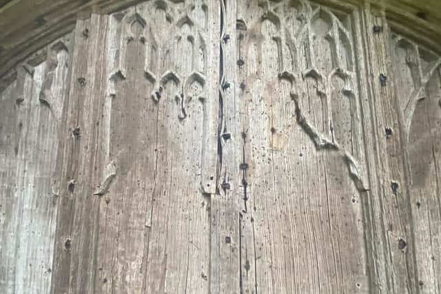 The damage to one of the doors at Collegiate Church of Holy Trinity.