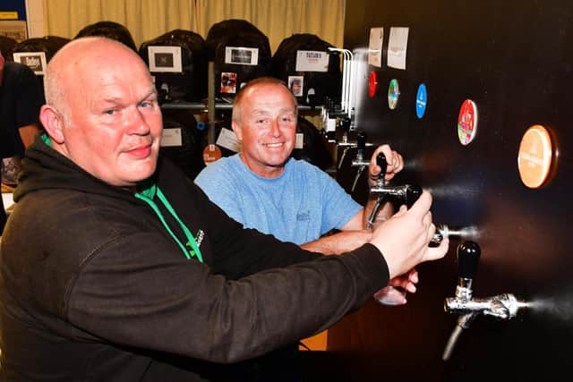 Matthew Haslem and Martin Wells busy pulling pints.