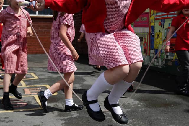 Children at St. George's C of E Primary School in Stockport, skip and play hop scotch during playtime.