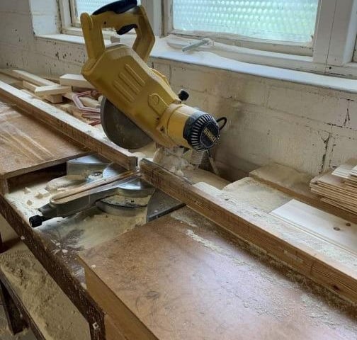 The chop saw at the Furniture Chest workshop, surrounded by dust. Photo: HSE