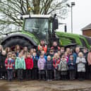Pupils and staff at Frithville Academy with staff and the tractor from Dyson Farming.