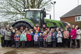 Pupils and staff at Frithville Academy with staff and the tractor from Dyson Farming.