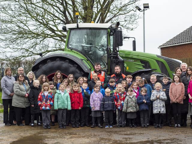 Pupils and staff at Frithville Academy with staff and the tractor from Dyson Farming.