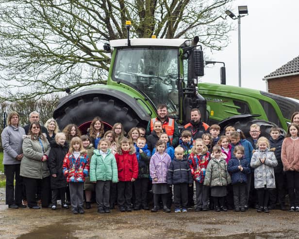 Pupils and staff at Frithville Academy with staff and the tractor from Dyson Farming.