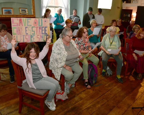 Campaigners trying to save Charles Street pond, singing 'Our Pond', lead by Tamsin Hunkin of Hope Sings Eternal singing group. 
Pictured is six-year-old Ella-Grace Collins with her banner.