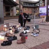 Council Leader Coun Richard Wright passes on his old trusty trainers at the memorial event.