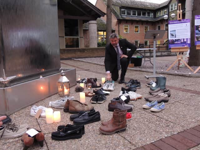 Council Leader Coun Richard Wright passes on his old trusty trainers at the memorial event.
