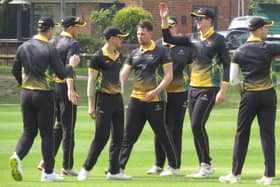 Alex King (no cap) celebrates a five wicket haul for Lincolnshire.