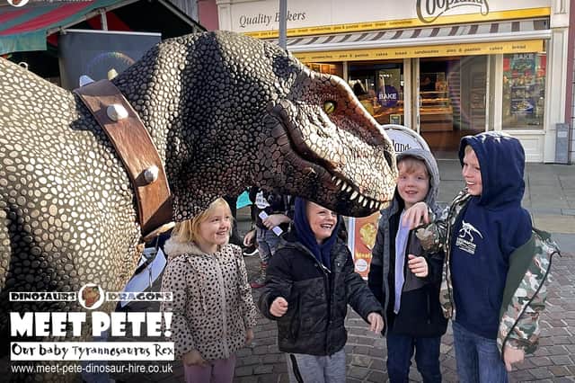Four-year-old Tyrannosaurus Rex, Pete the Dinosaur, meeting some of the children