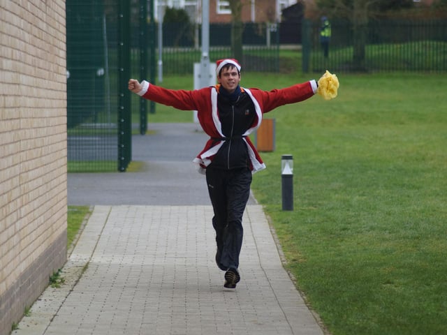 All cheers as runner Peter is first to complete two laps of the course