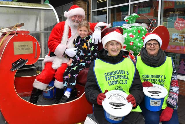 Santa with Esmay King, 6, and Lions pictured from left, Jackie Jewell and Jenny Ward.