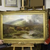 James Laverack and Tessa Laverack with Louis Hurt's painting of cattle by a stream in the Highlands. Image: Taylor's