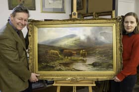 James Laverack and Tessa Laverack with Louis Hurt's painting of cattle by a stream in the Highlands. Image: Taylor's