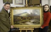 James Laverack and Tessa Laverack with Louis Hurt's painting of cattle by a stream in the Highlands. Image: Taylor's